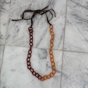 Necklace of beaded chain with velvet tie